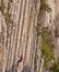 Rock climber on vertical difficult stone wall