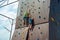 Rock climbing on an artificial rise. The boy climbs on the wall in an extreme park