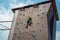 Rock climbing on an artificial rise. The boy climbs on the wall in an extreme park
