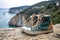 rock climbing shoes next to chalk bag on cliff