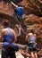 Rock climbing, support and friends with challenge and rope for adventure gear and outdoor exercise. Mountain, sport and