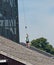 Rock climbing tower with young adults, teenagers abseiling.