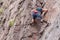 Rock climbing. A young climber climbs a vertical granite rock. Extreme sport.