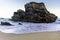 Rock on coastline of sandy Adraga beach, Portugal coast