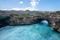 Rock coastline. Stone arch over the sea. Broken beach, Nusa Penida