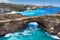 Rock coastline. Stone arch over the sea. Broken beach, Nusa Penida