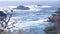 Rock crag of cliff, ocean beach, Point Lobos, California coast. Waves crashing.