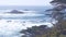 Rock crag of cliff, ocean beach, Point Lobos, California coast. Waves crashing.