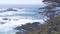 Rock crag of cliff, ocean beach, Point Lobos, California coast. Waves crashing.