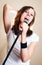Rock female vocalist on gray background