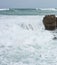 A rock and foamy and wavy sea on the Great Ocean Road in Australia