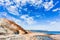 Rock formation on crystal clear beach with good weather