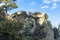 Rock formation on the side of cliff or ravine on mountain precipice for hikers to sit and for adventurers to rest upon