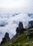 Rock formations in grassy mountains above the clouds at Mount Kisokoma