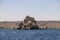 Rock formations in Nasser lake with beautiful blue water, at Aswan High Dam on the Nile river in Egypt. View over the huge stones.