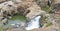 Rock Formations and Waterfall