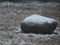 Rock on the ground covered with a light dusting of snow