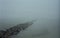 Rock Groyne in Foggy Baltic Sea