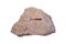 Rock hammer on arkosic sandstone rock isolated on white background.