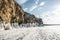 Rock on the ice of winter Baikal on Olkhon island in Siberia. Beautiful nature: mountains, frozen lake, blue sky