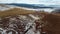 Rock on the ice of winter Baikal on Olkhon island in Siberia. Beautiful nature: mountains, frozen lake, sky.