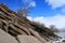 Rock layers or strata formation with dry tree and snow in the steppe of Mongolia