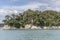 Rock and lush vegetation on cape at Frenchman bay, Abel Tasman park , New Zealand