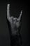 Rock and metal, full black hand shows goat sign