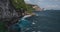Rock ocean shore timelapse aerial viea with dramatic crashing waves at cliff in Indonesia