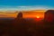 Rock outcrops of Monument Valley silhouetted ar sunset