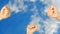 Rock paper scissors hand game. Three hands bottom view. Blue sky clouds background.