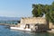 Rock retaining wall and historic fortification with path around coastline at Nafplio