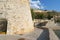 Rock retaining walls and historic fortification with path around coastline at Nafplio