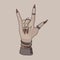 Rock and roll sign. Witch\\\'s hand. Gothic style. Rock festival. Decoration on the hands. Bracelets, rings.