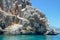 Rock in the sea against the sky and mountains