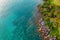 Rock in the sea beach from drone angle to the clearly sea water. It can see the sand behind the sea