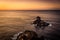 Rock in the sea with sunset. Landscape on the coast with cliffs and rocks in the ocean. Santo Domingo viewpoint on La Palma,