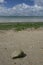 Rock on seaweedy beach overlooking Solent