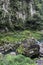 Rock, shimenawa rope, and river around Takachiho Gorge