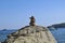 Rock stack beside the ocean on a calm, sunny day in Greece