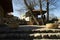 Rock stairs with decorative stone vases old wooden houses and a brick wall with arch gate background