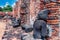 Rock statues sit along a crumbling wall at the ancient historic city of Ayutthaya