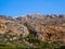 Rock and stone hills with scarce vegetation, bushes and small trees - Greece