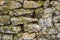 Rock wall built stacked stone moss background