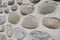 Rock wall of natural river stones. Round stones wall background. River round Stones pattern. Stones texture. River rocks.