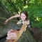 Rockclimber helping to female climber to reach top of mountain