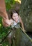 Rockclimber helping to female climber to reach top of mountain