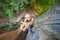 Rockclimber helping to female climber to reach top of mountain