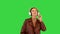 Rocker girl listening to music in headphones on a Green Screen, Chroma Key.