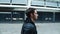 Rocker man walking street in black jacket. Young man walking in empty city.